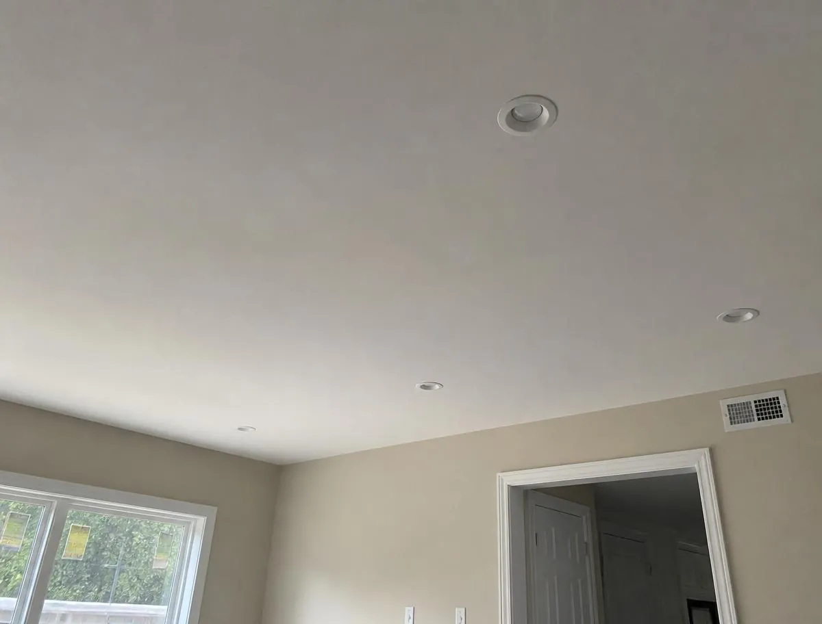 Residential room with a smooth finished drywall ceiling